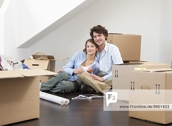 Smiling couple with cardboard boxes