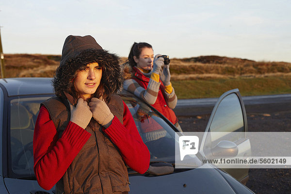 Women admiring landscape from roadside