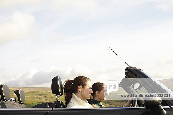 Women driving in rural landscape
