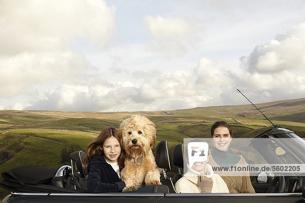 Family driving in rural landscape