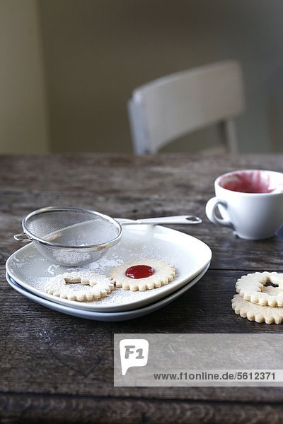 Christmas cookies with plates and sieve