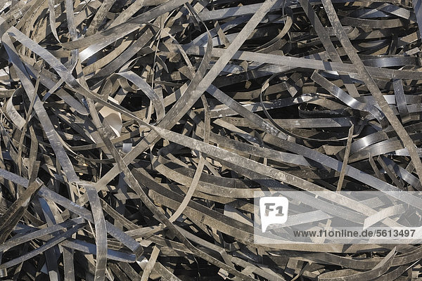 Pile of discarded metal straps at a scrap metal recycling centre  Quebec  Canada