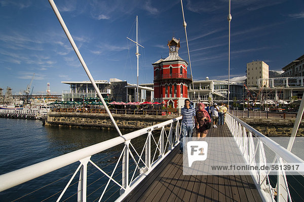 People crossing a swing bridge  Nelson Mandela Gateway  Clock Tower  Victoria & Alfred Waterfront  Cape Town  Western Cape  South Africa  Africa
