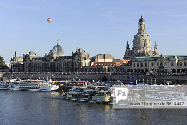 Dresden City Festival  Terrassenufer waterfront and Bruehl's Terrace  Elbe River and boats  a hot air balloon in the sky  Frauenkirche church at the back  Saxony  Germany  Europe