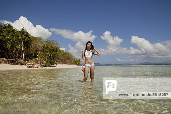 Young pretty Asian woman in a bikini on an idyllic beach on Pandan Island in Honda Bay near Puerto Princesa  Palawan Island  Philippines  Asia