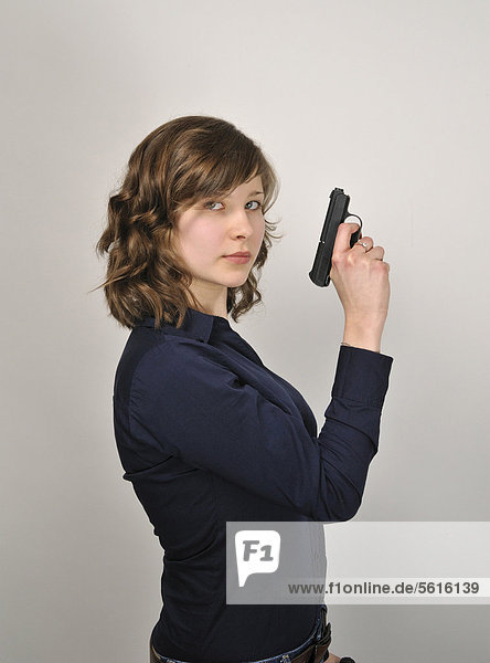 Young woman  20  holding a pistol