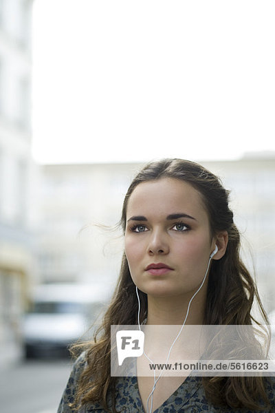 Young woman listening to music with earphones