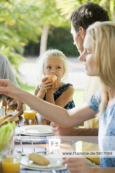 Mädchen beim Essen mit der Familie im Freien