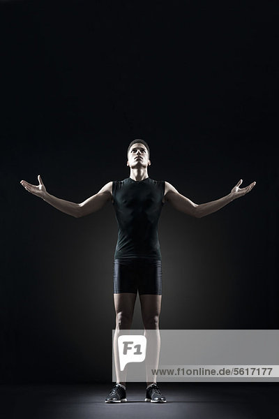 Male athlete with arms outstretched  portrait