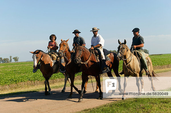 Gauchos on horseback  Estancia San Isidro del Llano towards Carmen Casares  Buenos Aires province  Argentina  South America