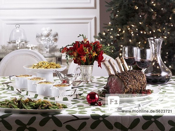 Christmas table with roast prime rib and side dishes