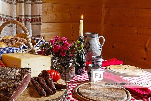 Marende (South Tyrolean supper) in a farmhouse dining room with bacon  sausage  cheese  bread and wine