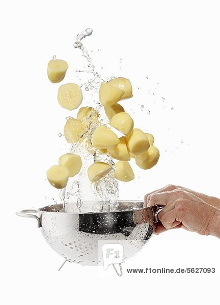 Geschälte Kartoffeln im Sieb waschen