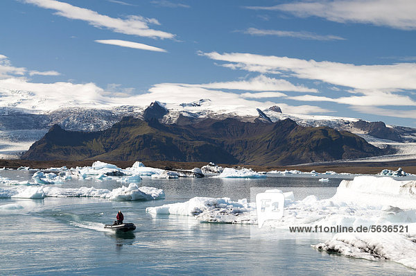 Zodiac raft or inflatable boat  blue and black ash-coloured icebergs  glacier lagoon of Joekuls·rlÛn  Vatnajoekull Glacier  Austurland  East Iceland  Iceland  Europe