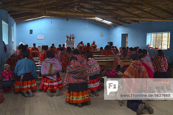 Traditionally dressed Indio community in a small church  Andes Mountains  near Cuzco  Peru  South America