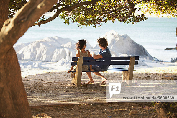 Couple overlooking view on park bench