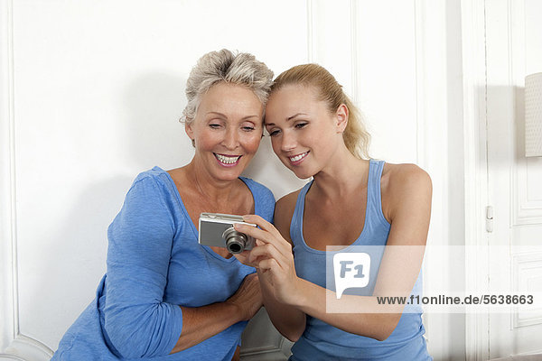 Mother and daughter looking at photos