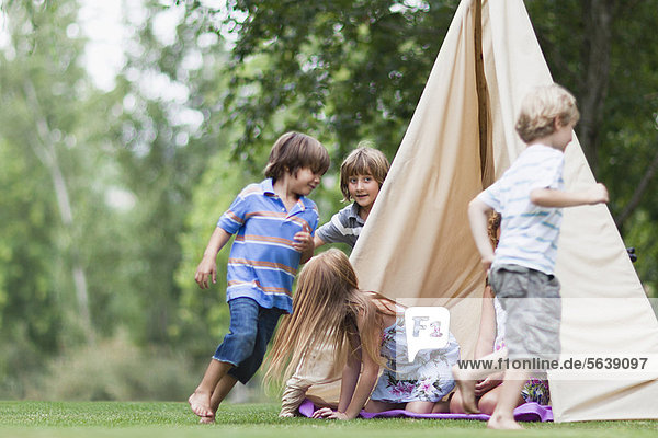 Kinder spielen im Zelt im Freien