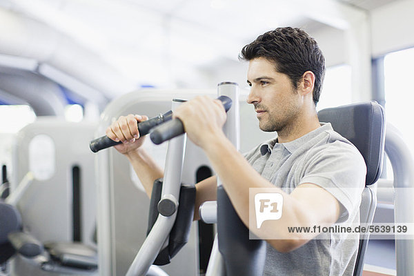 Man using weights machine in gym