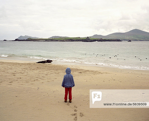 Girl standing on empty beach
