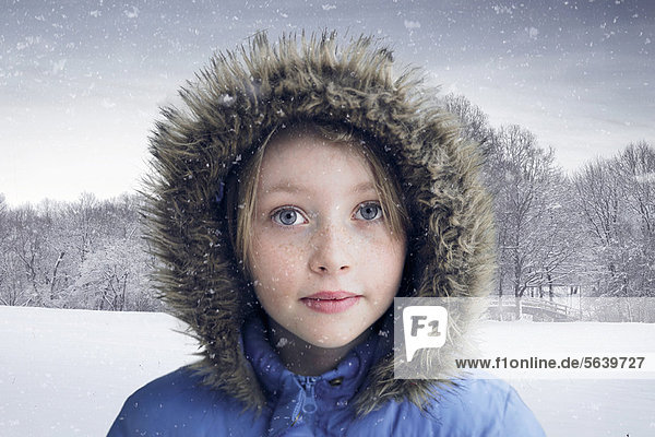 Girl wearing fur parka in snow