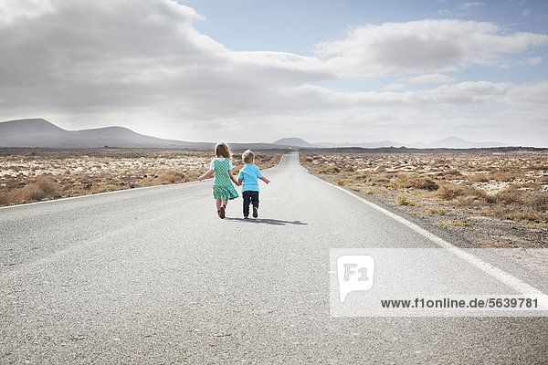 Children walking on paved rural road
