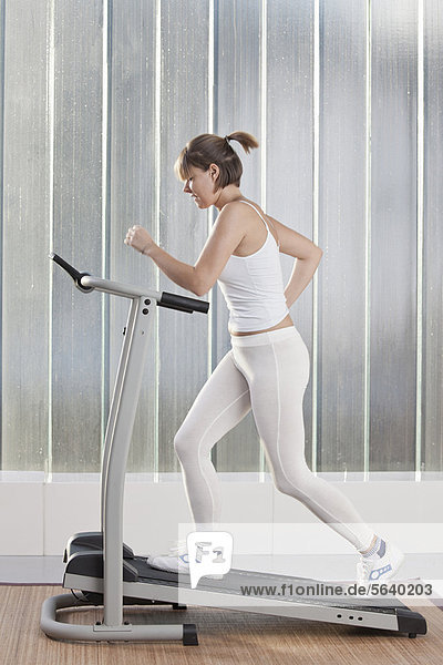 Woman using exercise machine