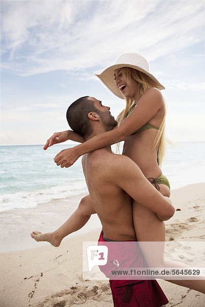 A playful young couple at the beach