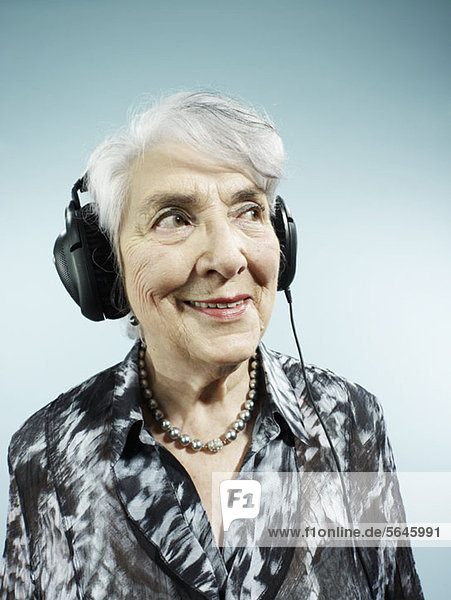 Eine ältere Frau mit Kopfhörer
