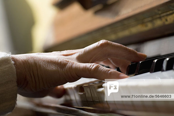 Piano chord pressed by woman's hand