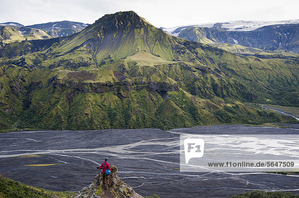 Hiker admiring the view across the Kross· River towards _tigoenguhoef_i Mountain  Utigoenguhoefdi  Go_aland  Godaland  _Ûrsmoerk  Thorsmoerk  Su_urland  Sudurland  Southern Iceland  Iceland  Europe