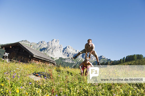 Austria  Salzburg  Filzmoos  Couple having fun in alpine meadow