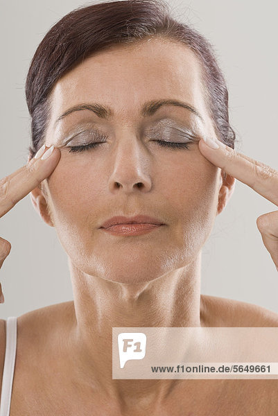 Mature woman with eyes closed  close up