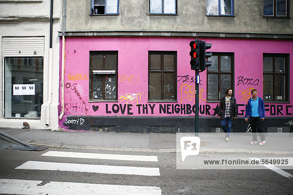 'Lettering on a pink house ''Love Thy Neighbour''  Oslo  Norway  Europe'