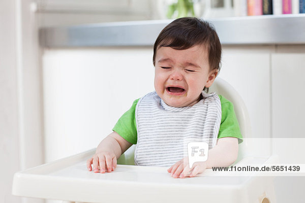 Baby boy in high chair  crying