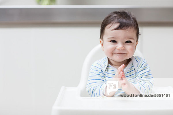 Happy baby in high chair