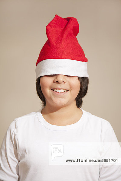 Boy wearing santa hat  smiling