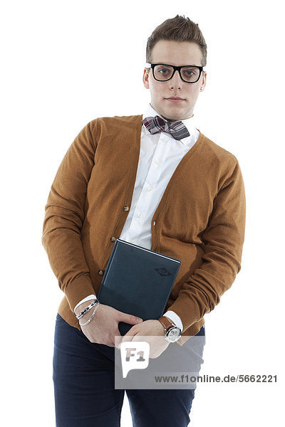Young man with glasses and bow tie holding a book  diary