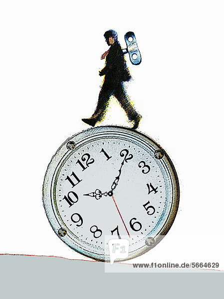 Wind-up businessman balancing on rolling clock