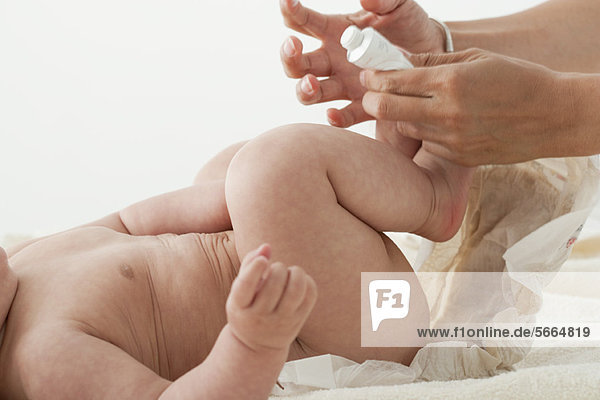 Infant having diaper changed  cropped