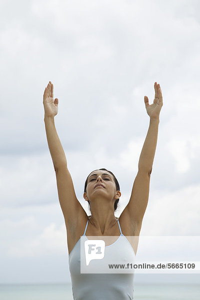 Mature woman in upward salute position