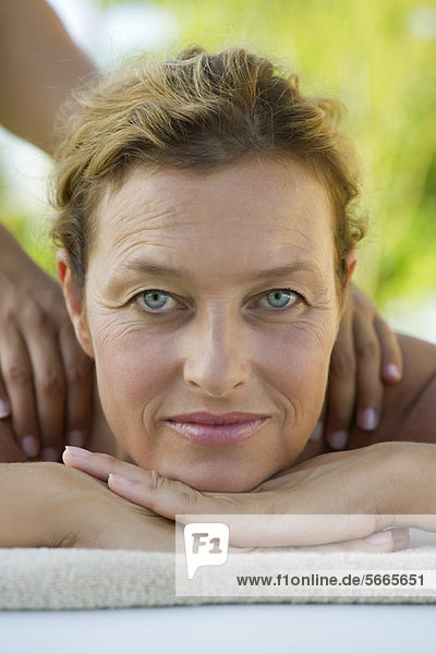 Mature woman getting massage  portrait