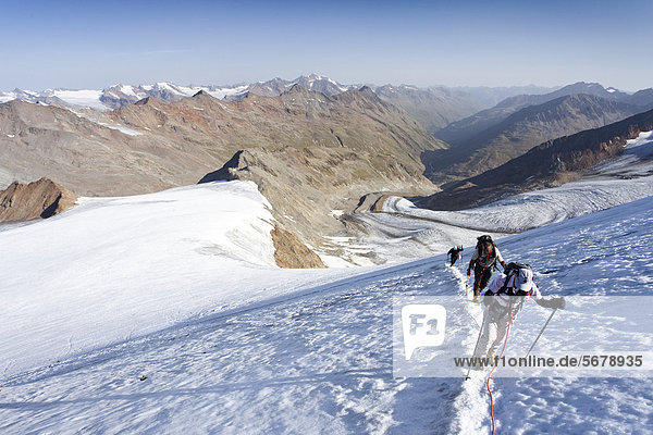 Hikers during the ascent to Similaun Mountain on Niederjochferner Glacier in Senales Valley  looking towards the Marzell ridge  Alto Adige  Italy  Europe