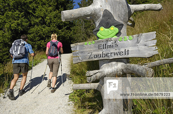 Signpost  Ellmis Zauberwelt  hikers on Hartkaiser mountain  Tyrol  Austria  Europe