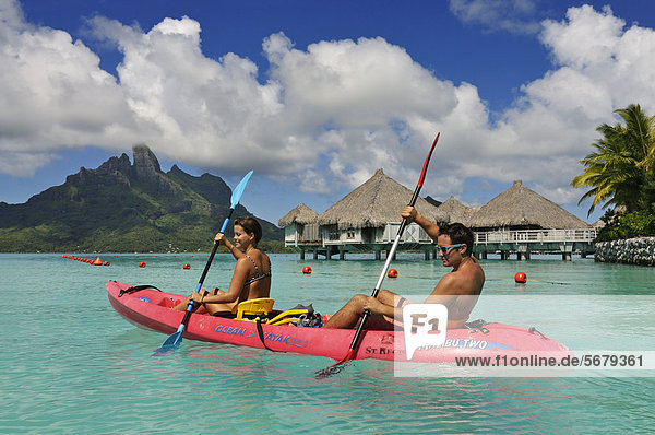 Tourists in a kayak  St. Regis Bora Bora Resort  Bora Bora  Leeward Islands  Society Islands  French Polynesia  Pacific Ocean