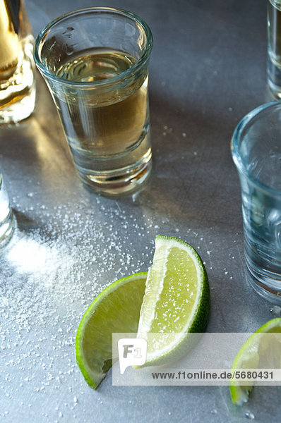 Tequila shots with lime wedges