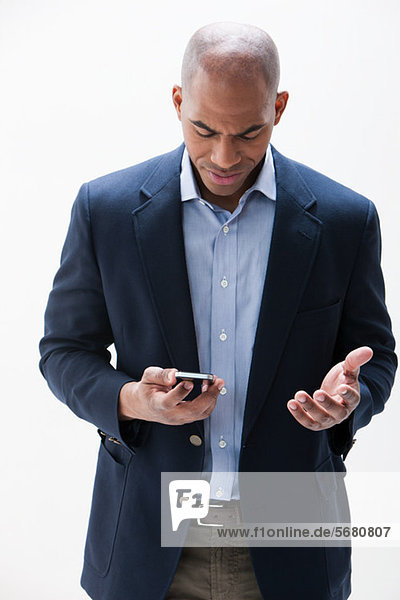 African American man using cellphone  studio shot