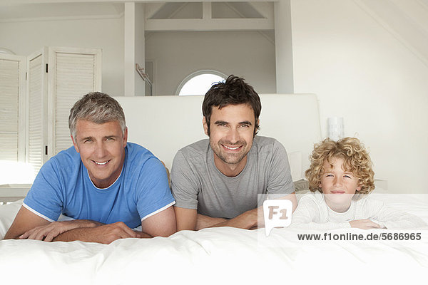 Three generations of men on bed