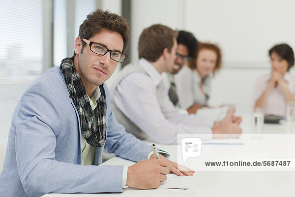 Businessman making notes in meeting