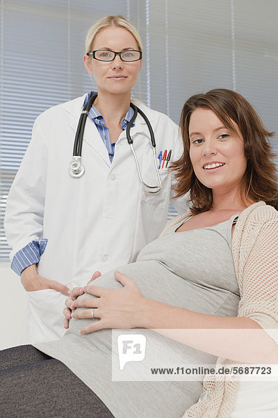 Doctor smiling with pregnant woman